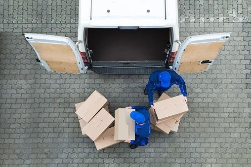 Aerial view of delivery van with worker loading boxes